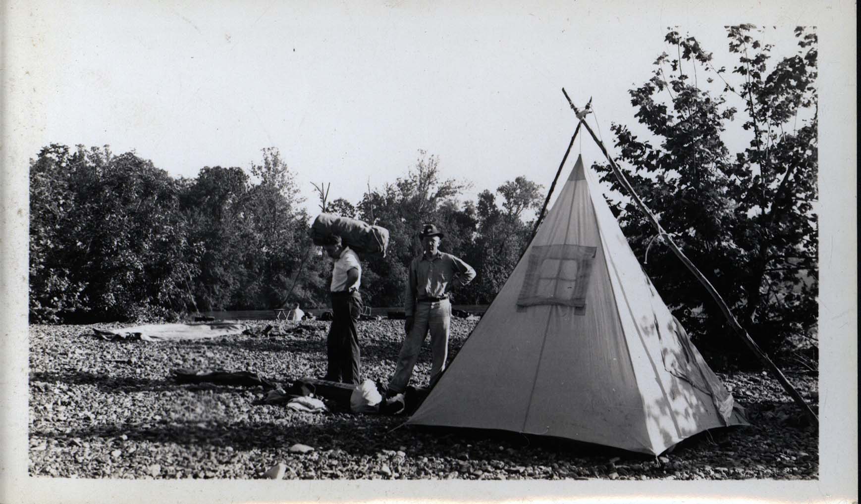 Photograph of Frederic Leopold next to tent