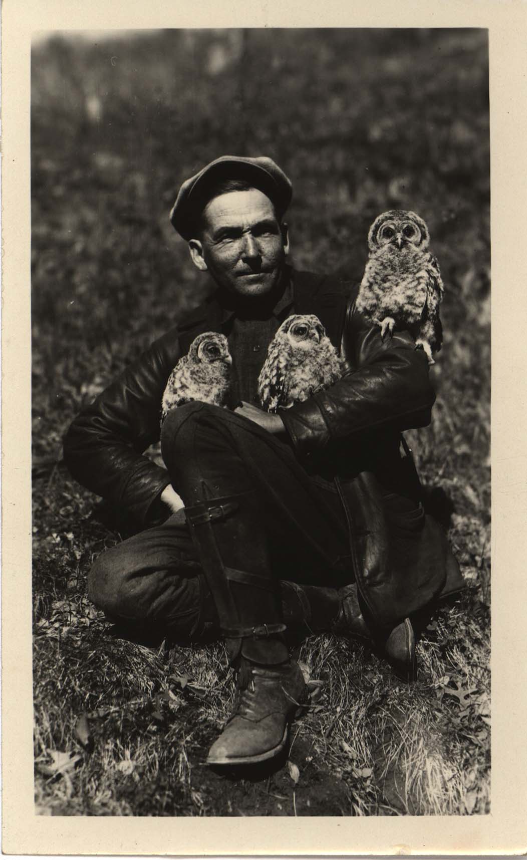 Photograph of Walter Rosene posing with owls